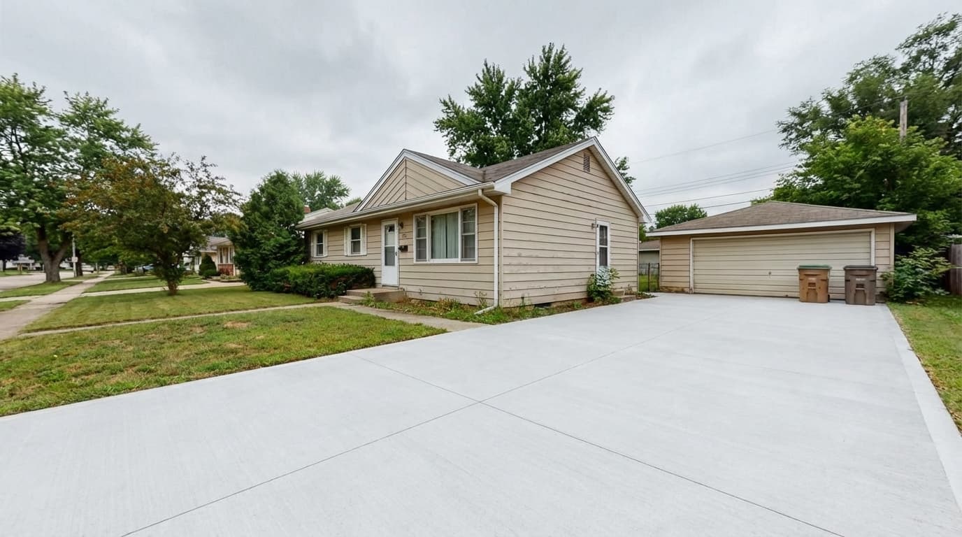 Freshly finished driveway in front of the same home after replacement